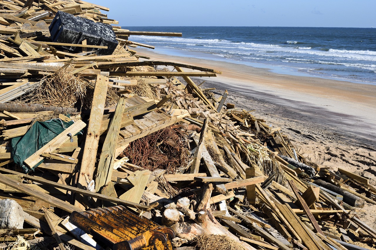 A large pile of wood from a damaged dock sits on a Florida beach after Hurricane Matthew.